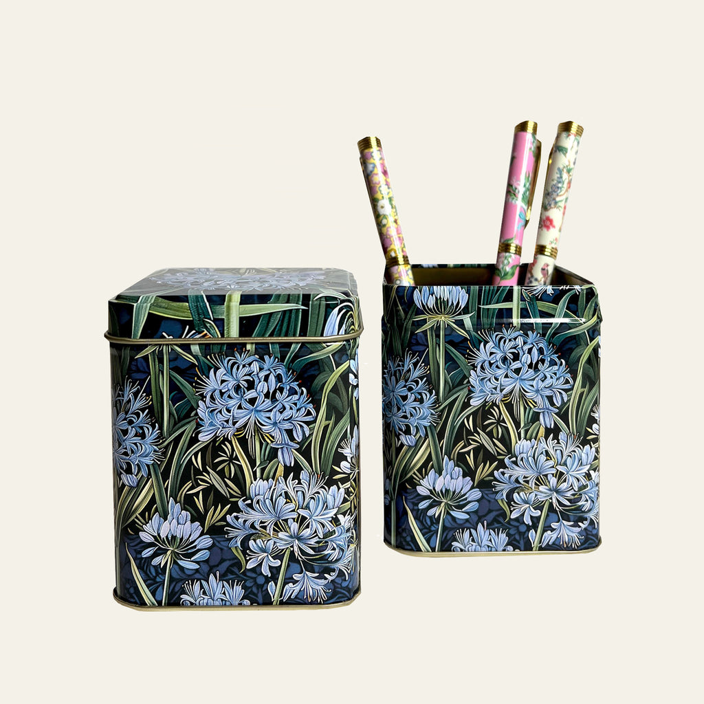 Small decorative tins (sold individually) with blue agapanthus flowers on all four sides by Arts & Crafts.
